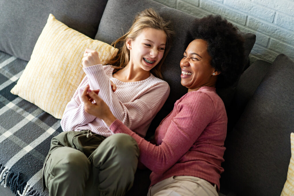 Loving african american foster care parent single mother embrace teen daughter. Giving support and protection, black mom hug teenage girl, family kindness concept,