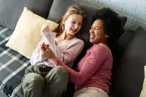 Loving african american foster care parent single mother embrace teen daughter. Giving support and protection, black mom hug teenage girl, family kindness concept,